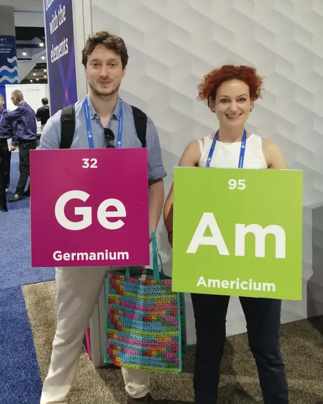 Guy Entract and a fellow chemist holding Germanium and Americium element boards at an American Chemical Society meeting